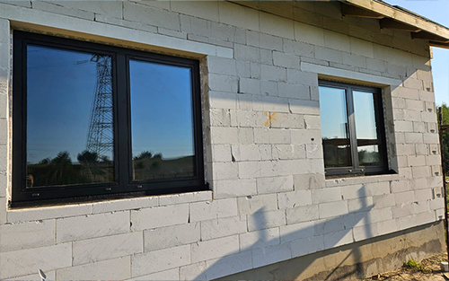 Close up of windows that were installed on a brick building.