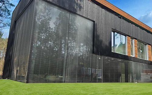 Modern home with glass windows and horizontal cross bar detailing.